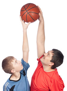 photo of father and son reaching for basketball
