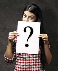 photo of woman holding card with question mark