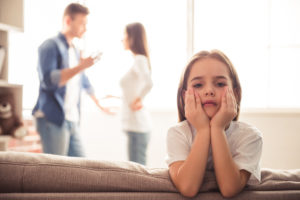 Child Custody Divorce Arizona. Child upset parents are fighting.